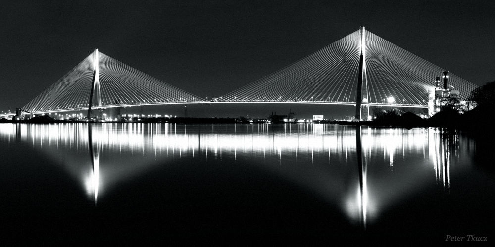 Gordie Howe International Bridge Noir photograph by Peter Tkacz Long exposure night photograph of Gordie Howe International Bridge over Detroit River, noir style, by Peter Tkacz